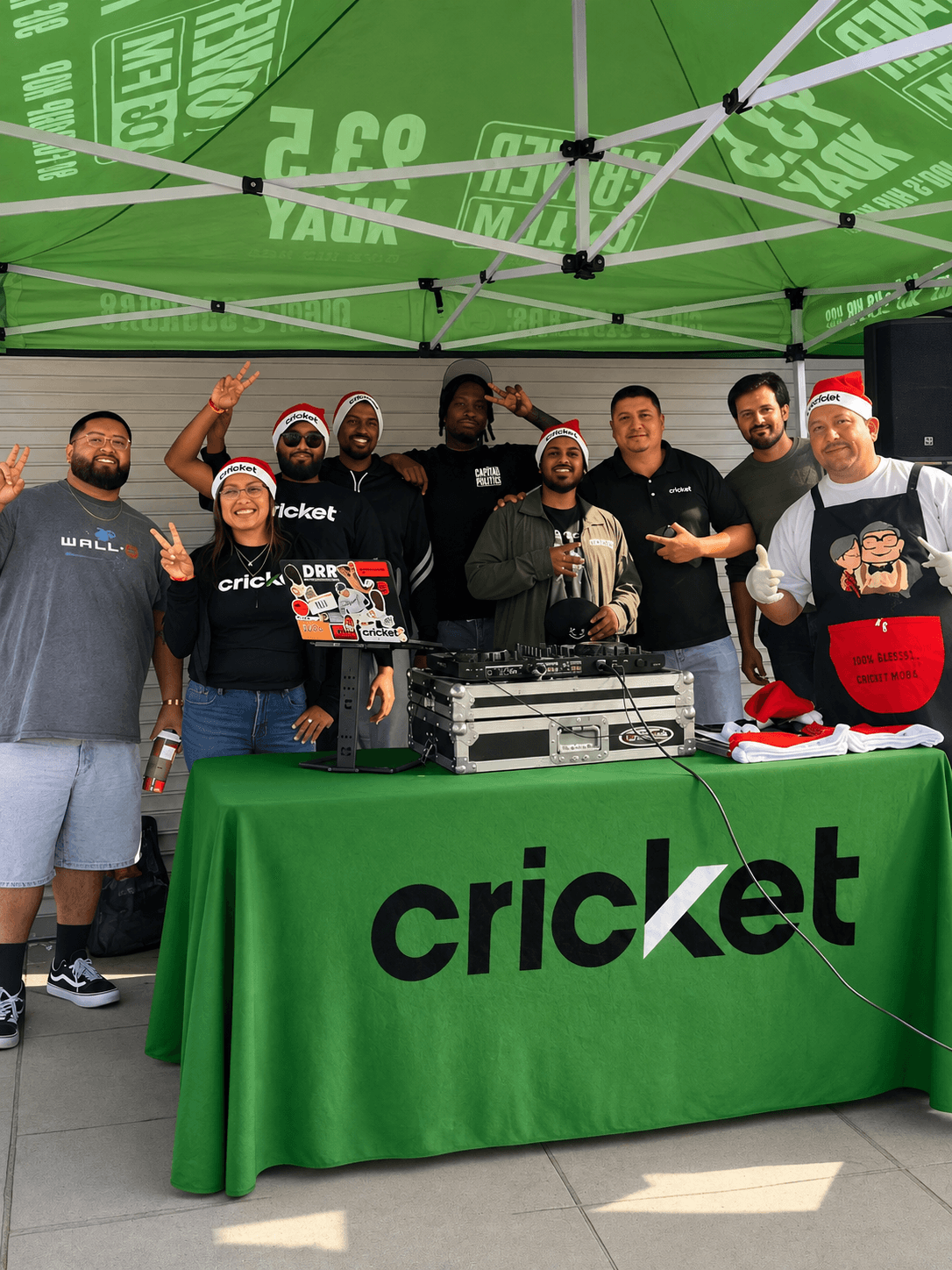 NKB team members gathered under a Cricket event canopy