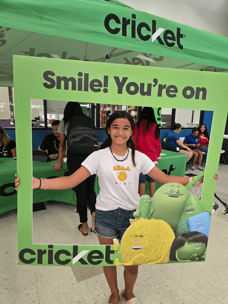 Young customer smiling at a Cricket Wireless community event